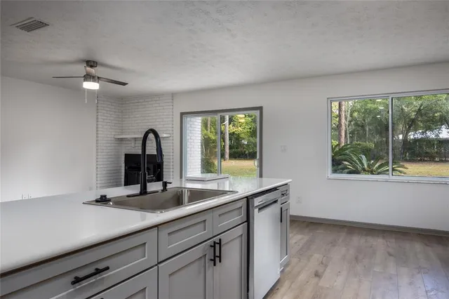 a kitchen with kitchen island granite countertop a sink stove and refrigerator