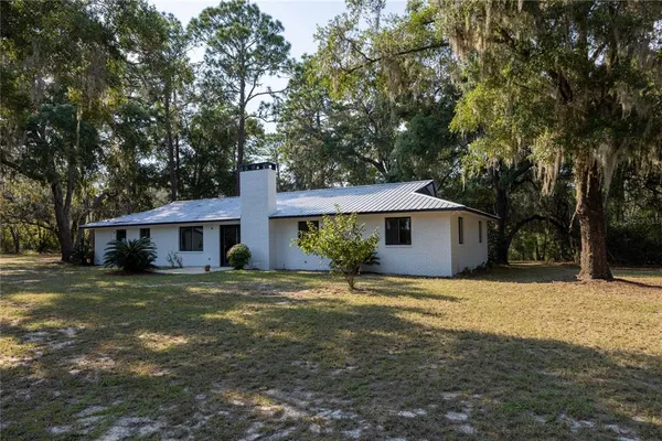 a view of a backyard with wooden fence