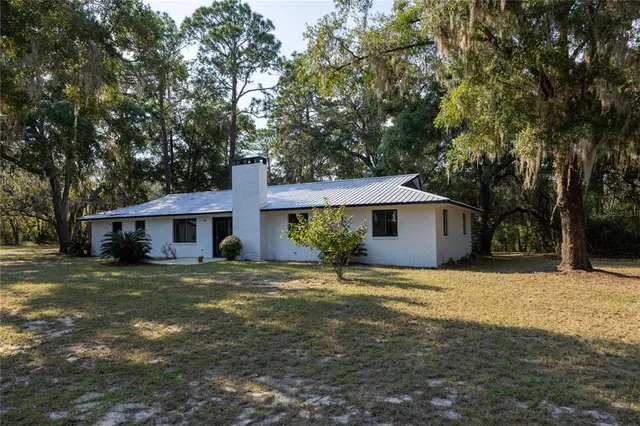 a view of a backyard with wooden fence