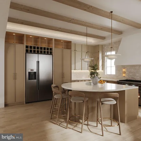 a kitchen with stainless steel appliances granite countertop a table chairs and a refrigerator