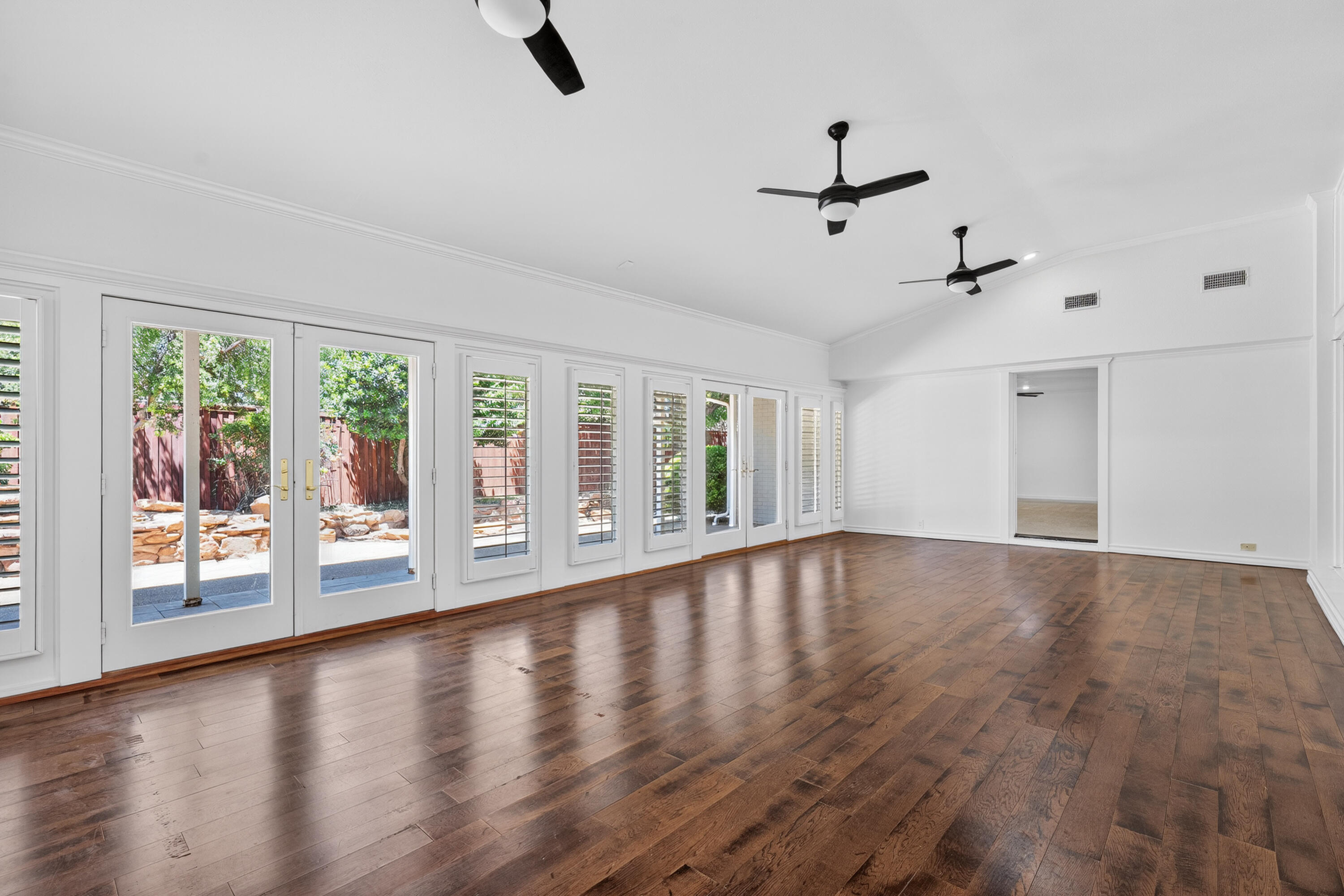 4616 9th Street Lubbock, TX 79416 - Photo 13 of 53 a view of an empty room with wooden floor and a window
