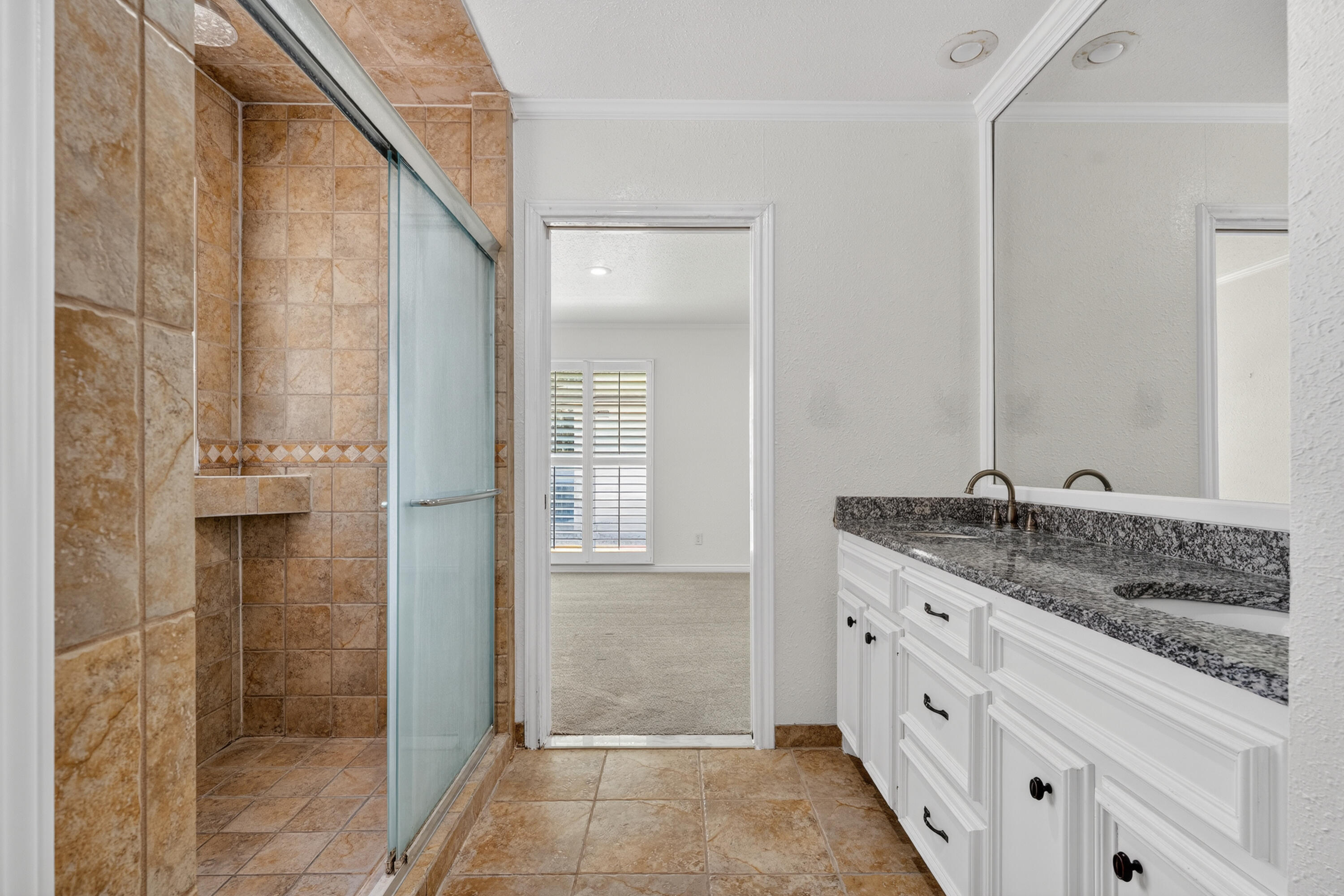 4616 9th Street Lubbock, TX 79416 - Photo 17 of 53 a bathroom with a granite countertop sink and a mirror