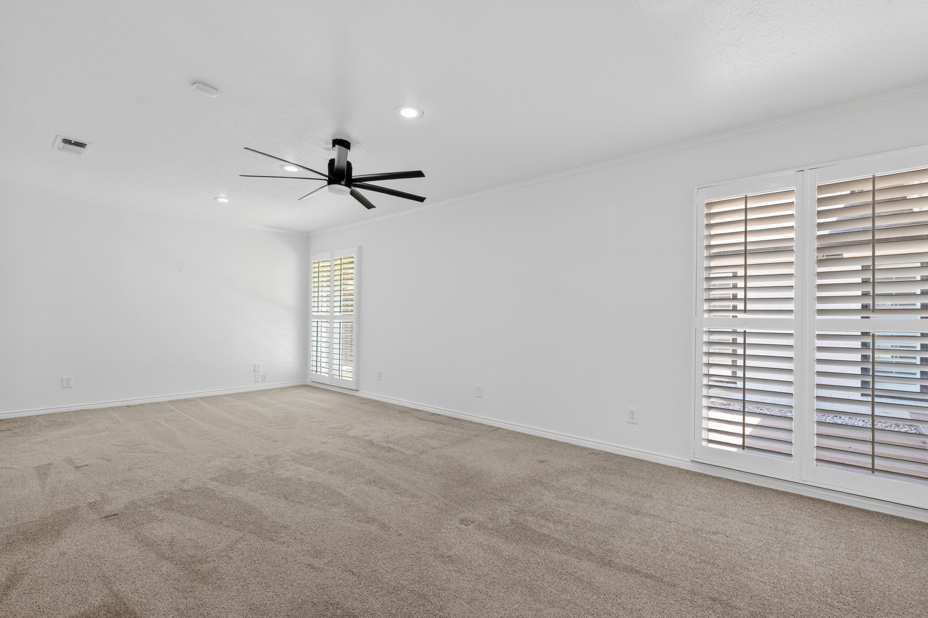 4616 9th Street Lubbock, TX 79416 - Photo 19 of 53 a view of a room with a ceiling fan and window