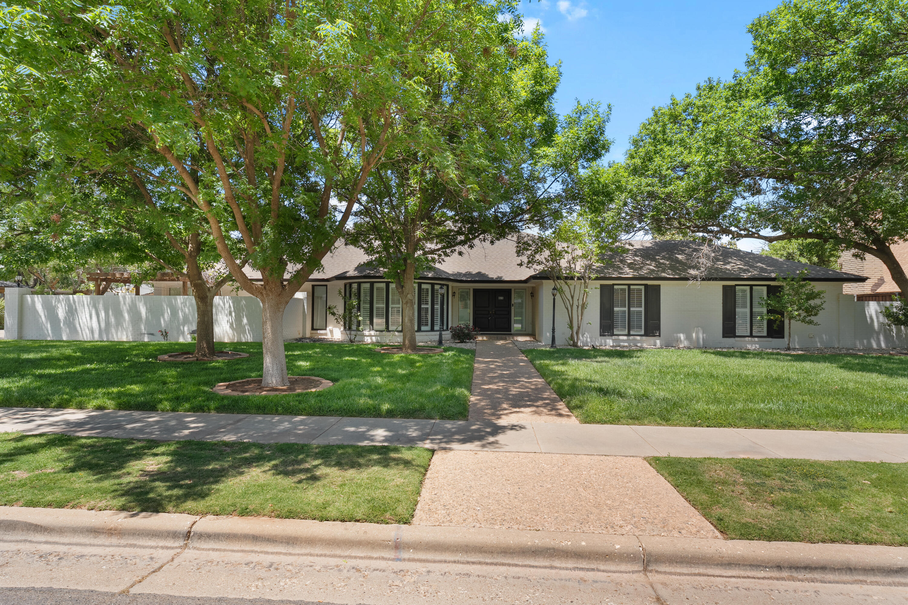 4616 9th Street Lubbock, TX 79416 - Photo 2 of 53 a front view of a house with a yard