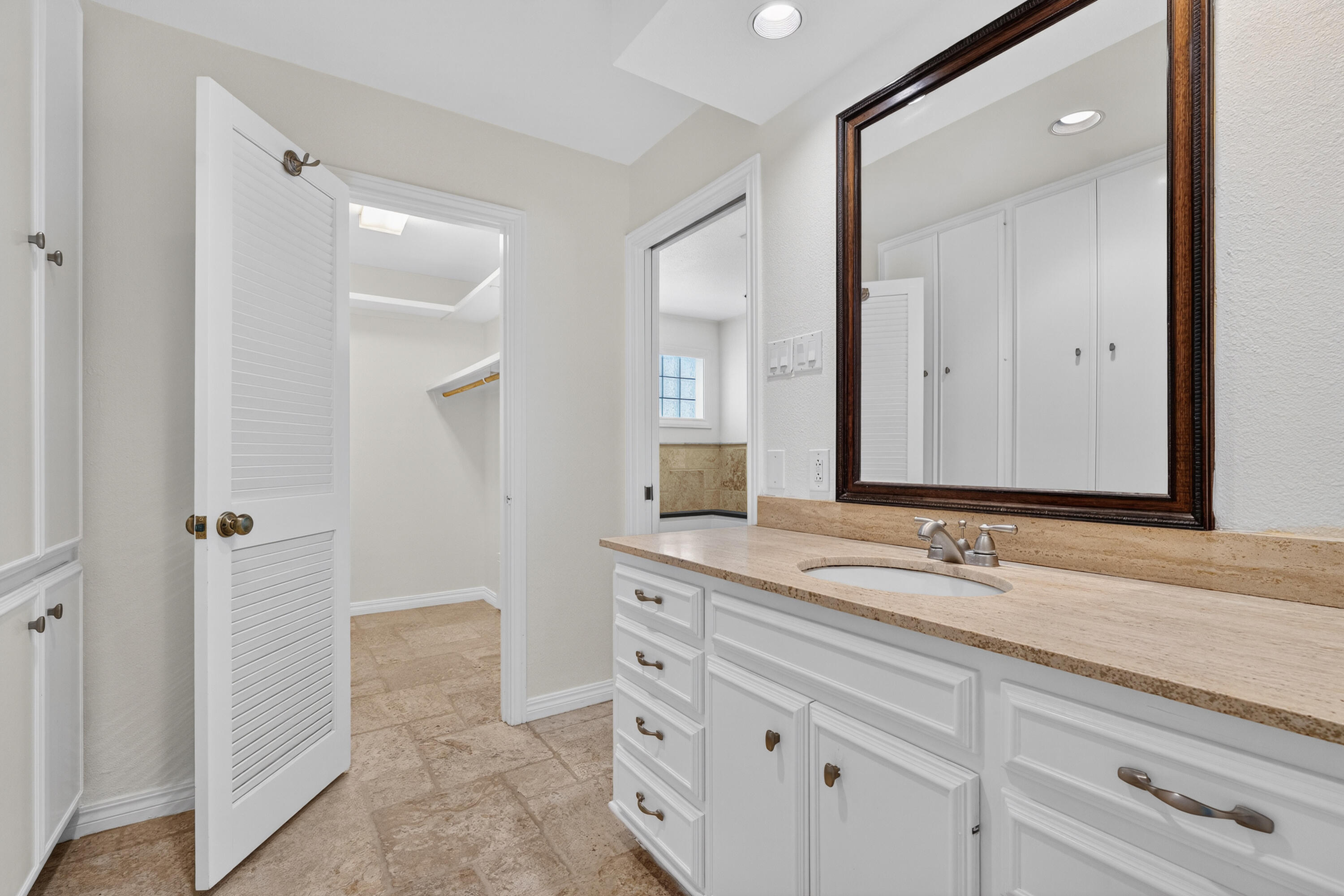 4616 9th Street Lubbock, TX 79416 - Photo 27 of 53 a bathroom with a sink and a mirror