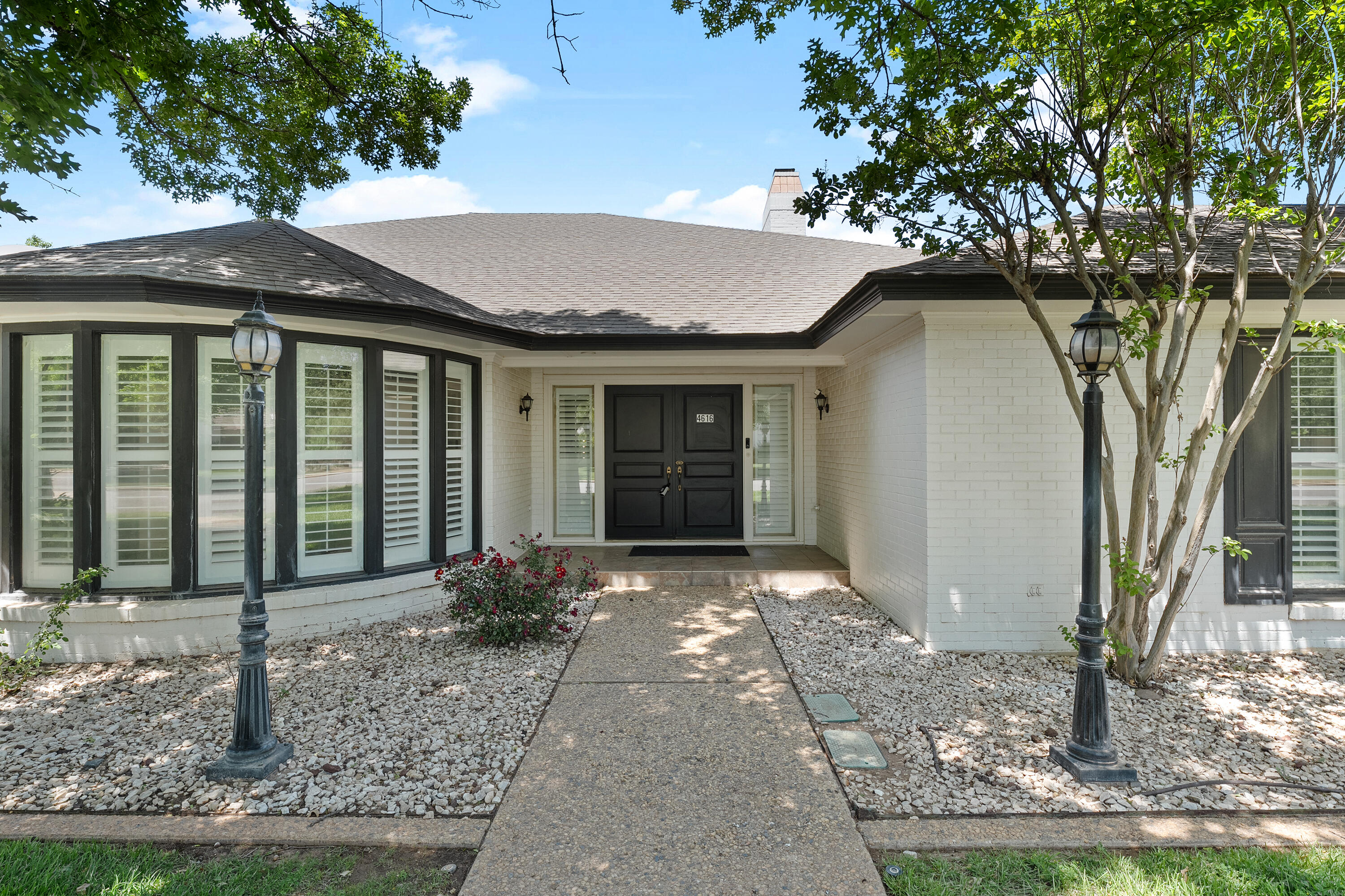 4616 9th Street Lubbock, TX 79416 - Photo 3 of 53 a front view of a house with garden
