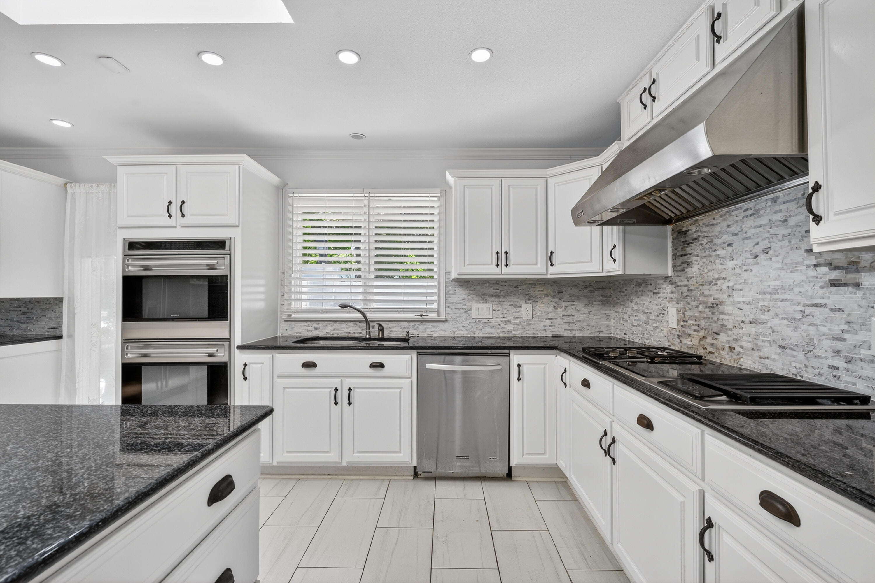 4616 9th Street Lubbock, TX 79416 - Photo 31 of 53 a kitchen with stainless steel appliances granite countertop a sink and stove top oven