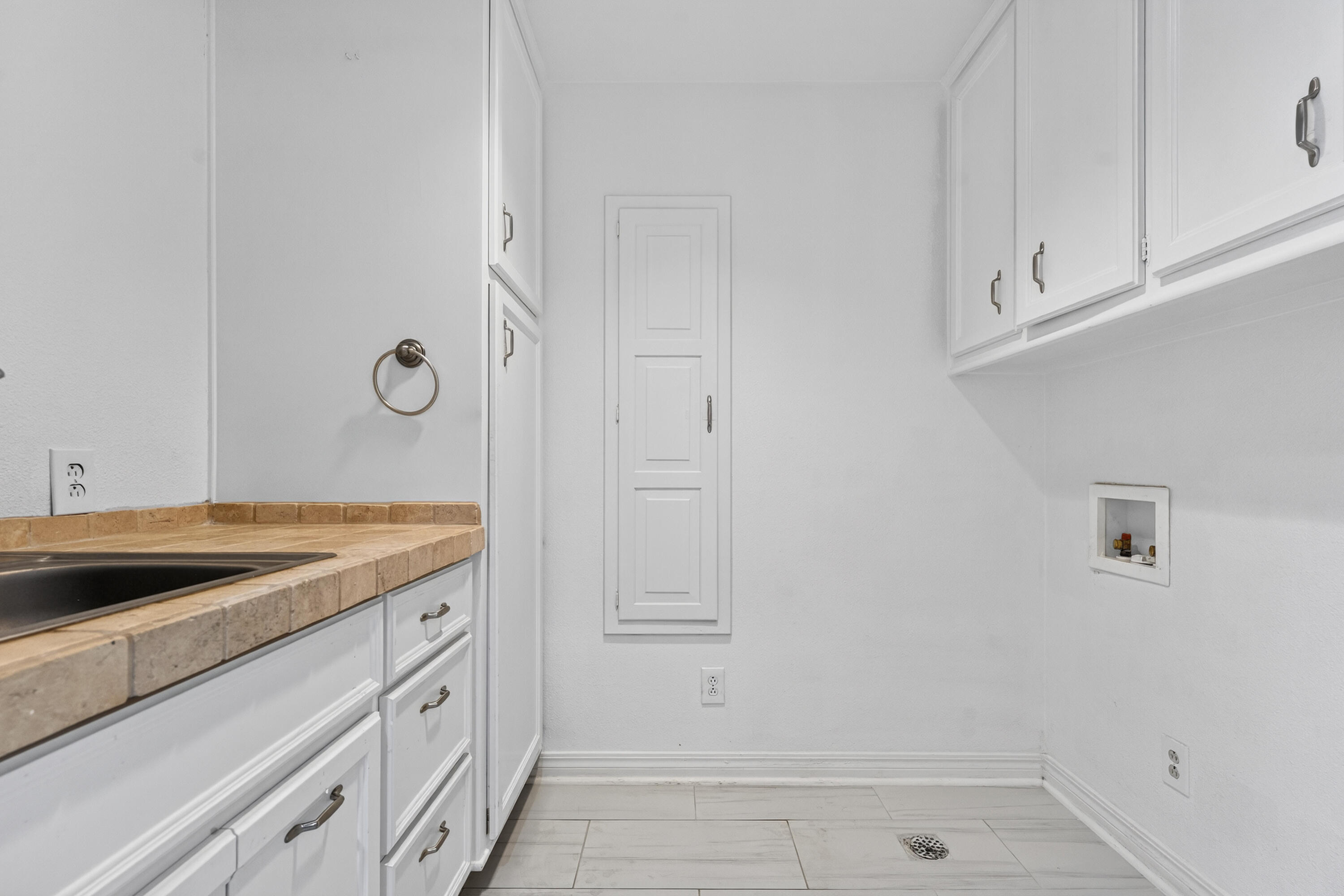 4616 9th Street Lubbock, TX 79416 - Photo 36 of 53 a bathroom with a granite countertop sink and white cabinets