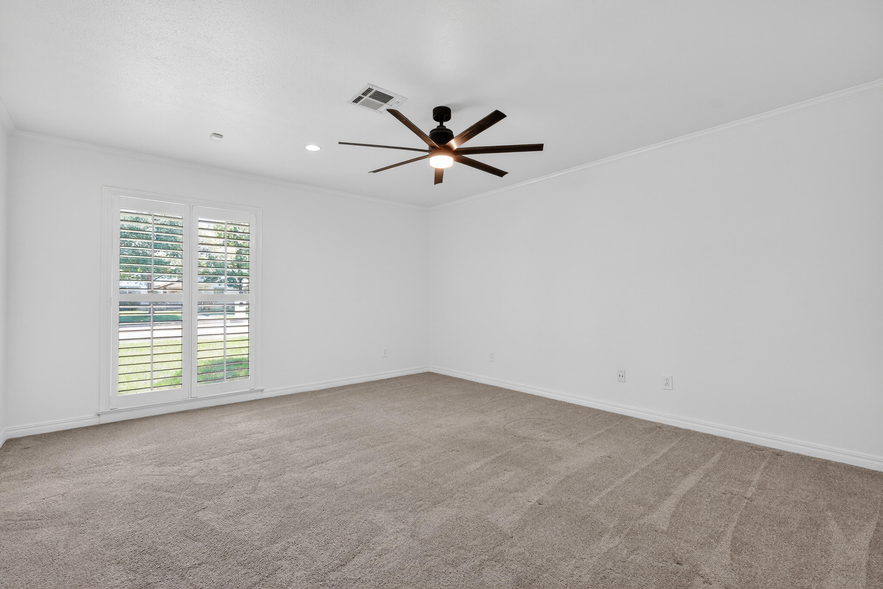 4616 9th Street Lubbock, TX 79416 - Photo 38 of 53 an empty room with a window and a fan