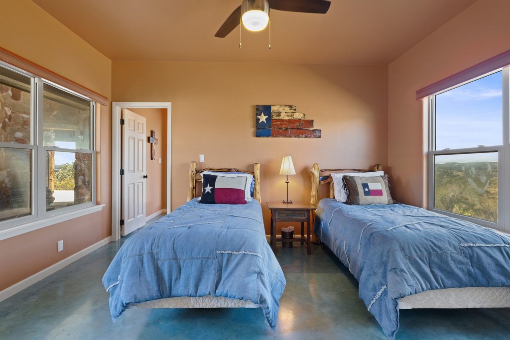 1292 Upper Turtle Creek Road Kerrville, TX 78028 - Photo 27 of 40 Bedroom with finished concrete flooring and ceiling fan