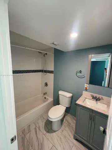 a bathroom with a toilet a sink and a shower
