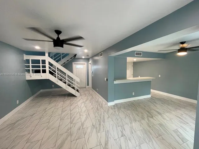 a view of a livingroom with a ceiling fan