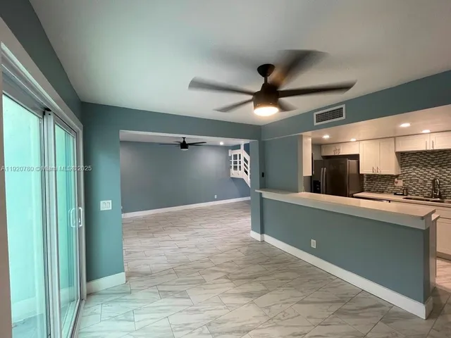 a view of kitchen with cabinets and outdoor space