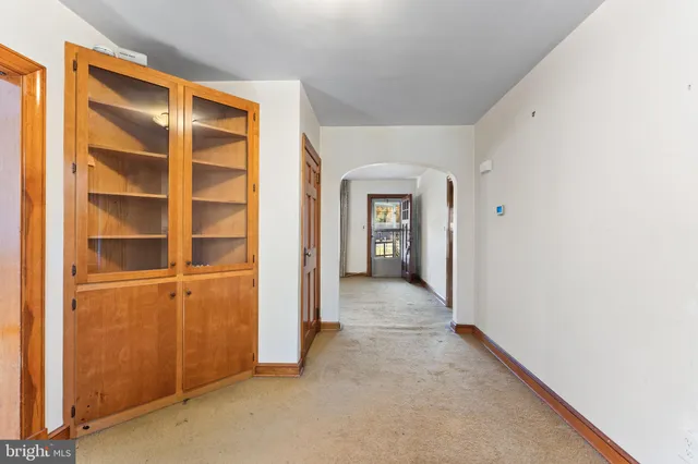 a view of an empty room with wooden door
