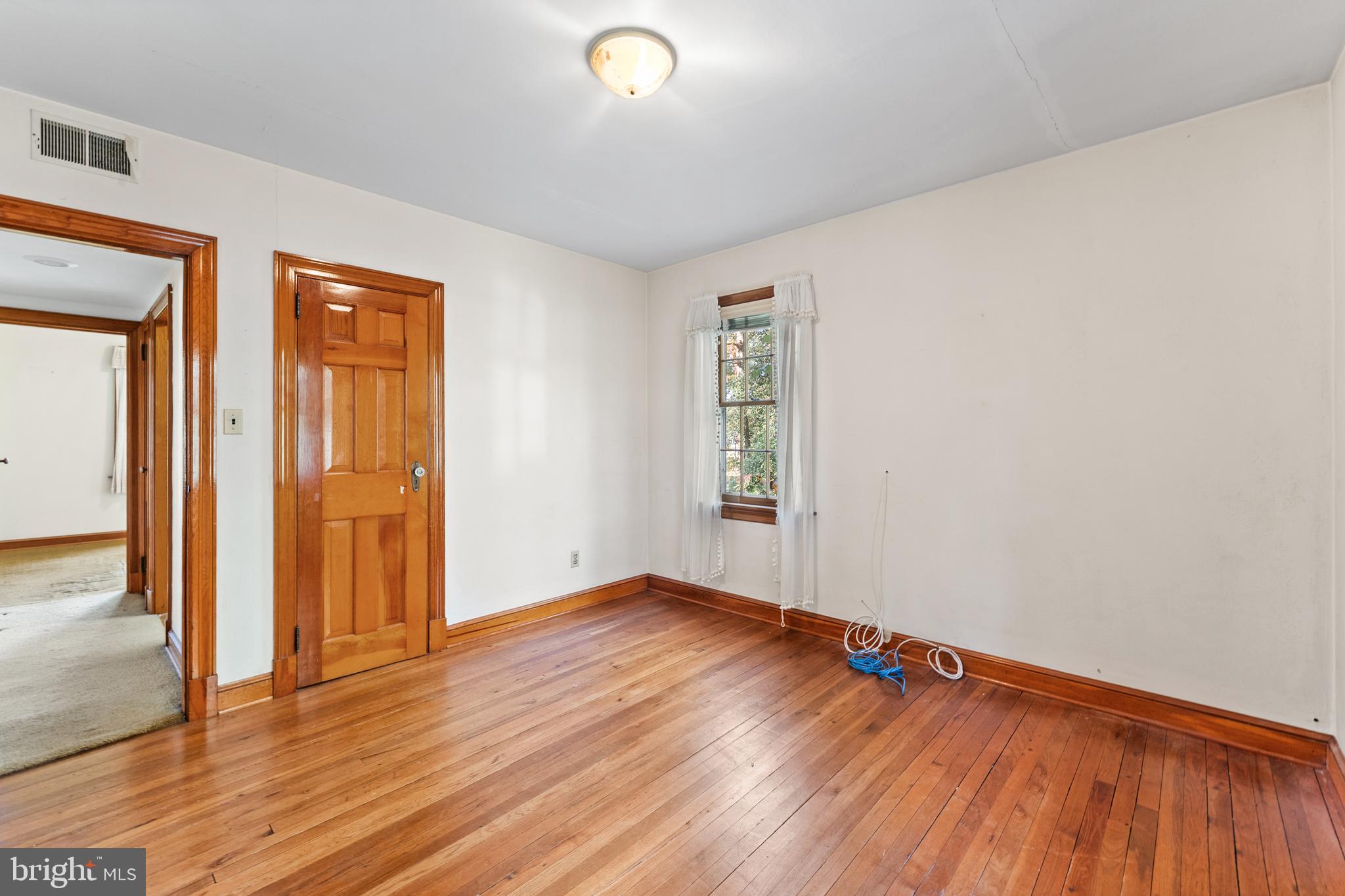 12606 Sub-Station Road Waldorf, MD 20601 - Photo 16 of 44 an empty room with wooden floor and windows