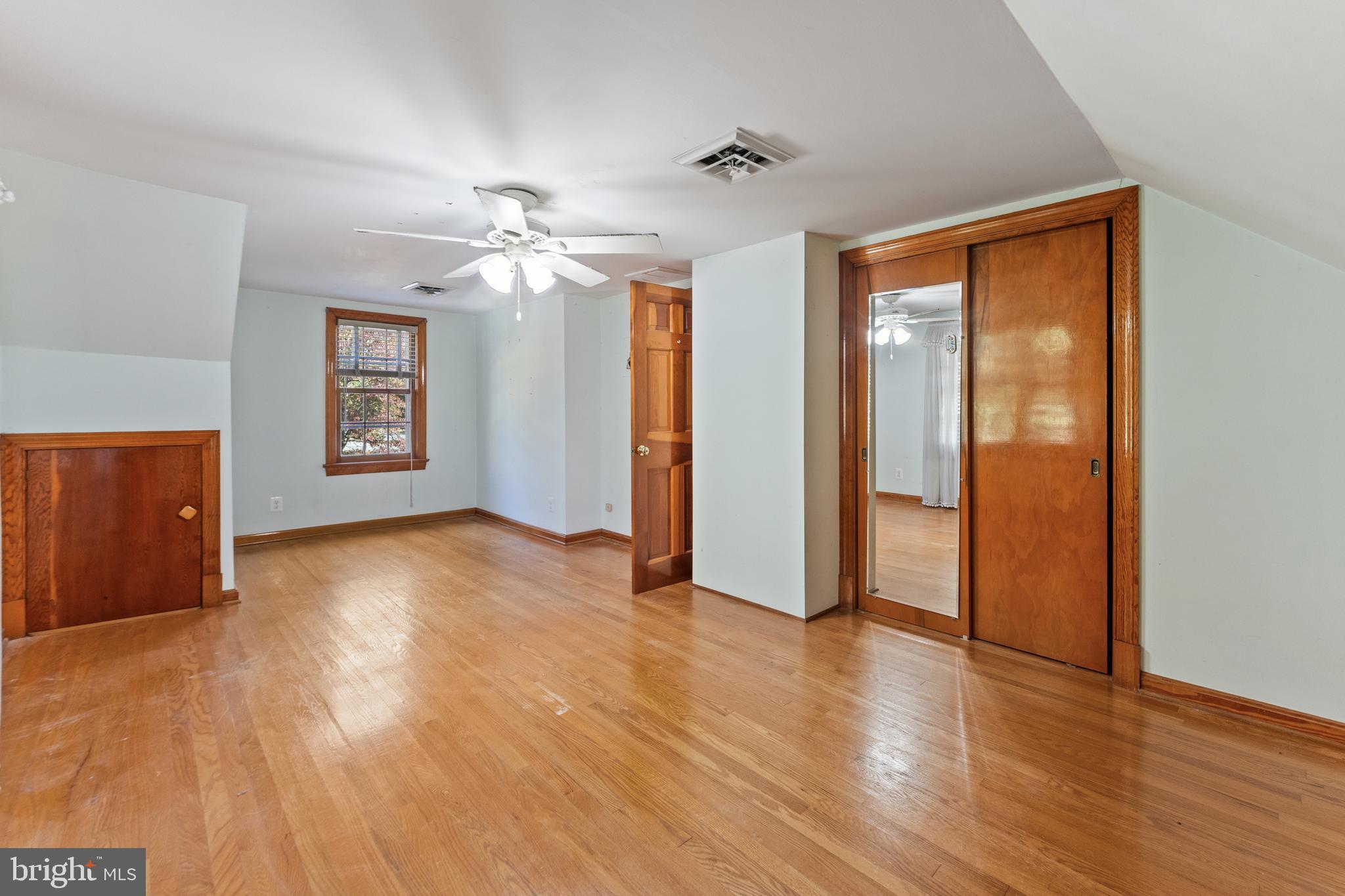 12606 Sub-Station Road Waldorf, MD 20601 - Photo 18 of 44 a view of an empty room with a window and wooden floor