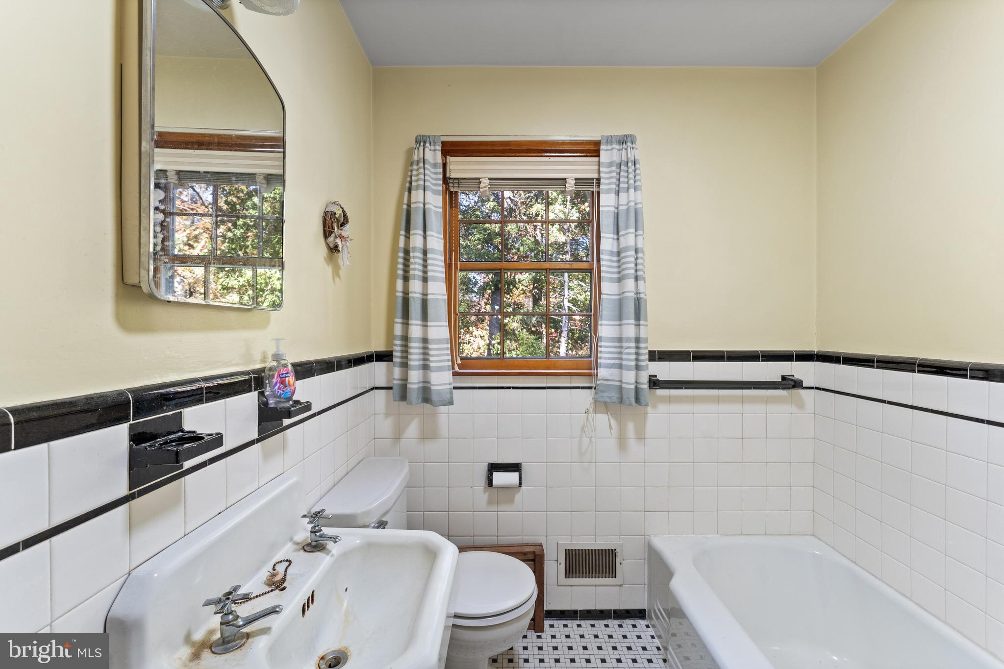 12606 Sub-Station Road Waldorf, MD 20601 - Photo 24 of 44 a bathroom with a tub a sink and a window