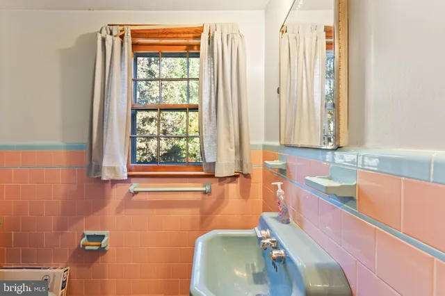 a bathroom with a tub sink and a large mirror