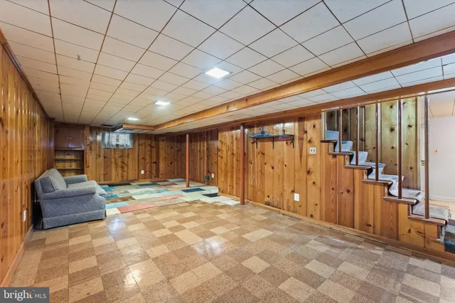 a view of a livingroom with furniture and staircase