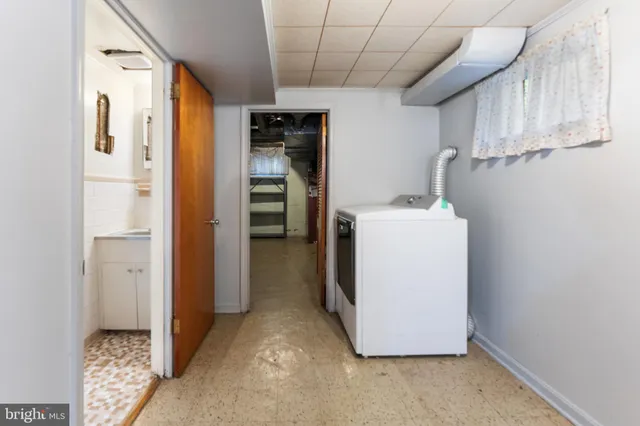 a utility room with cabinets washer and dryer