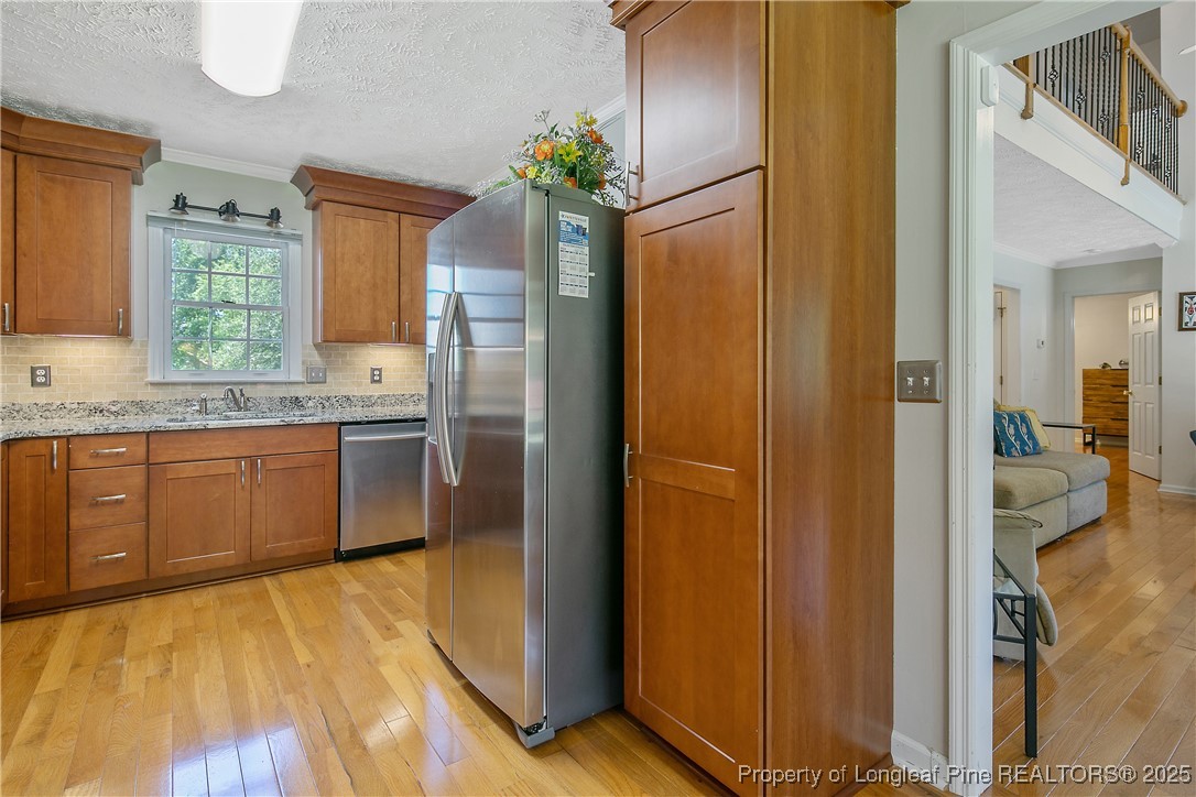 6528 Foxberry Road Fayetteville, NC 28314 - Photo 18 of 50 a kitchen with stainless steel appliances granite countertop a refrigerator and a sink