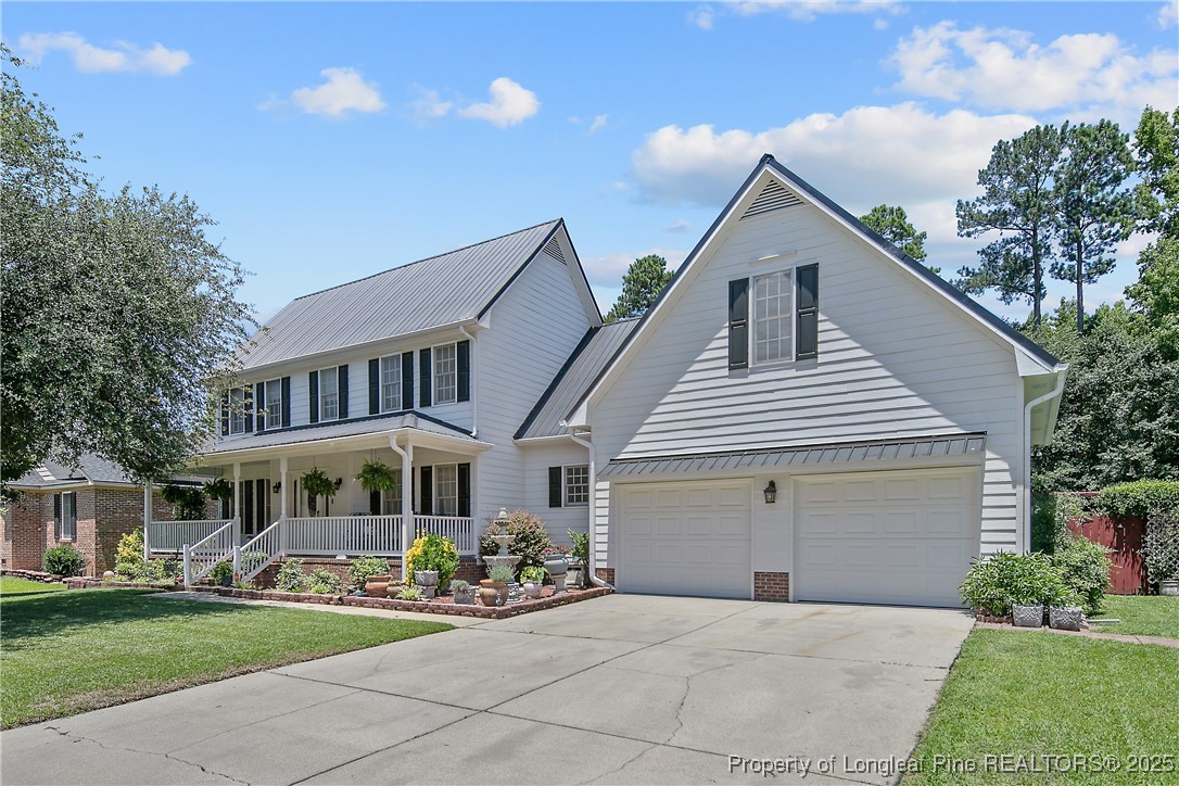6528 Foxberry Road Fayetteville, NC 28314 - Photo 2 of 50 a front view of a house with a yard and porch