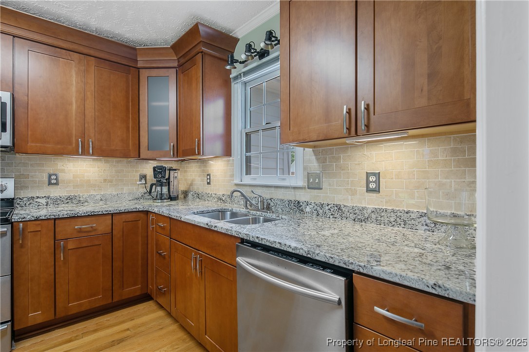 6528 Foxberry Road Fayetteville, NC 28314 - Photo 21 of 50 a kitchen with stainless steel appliances granite countertop a sink and cabinets