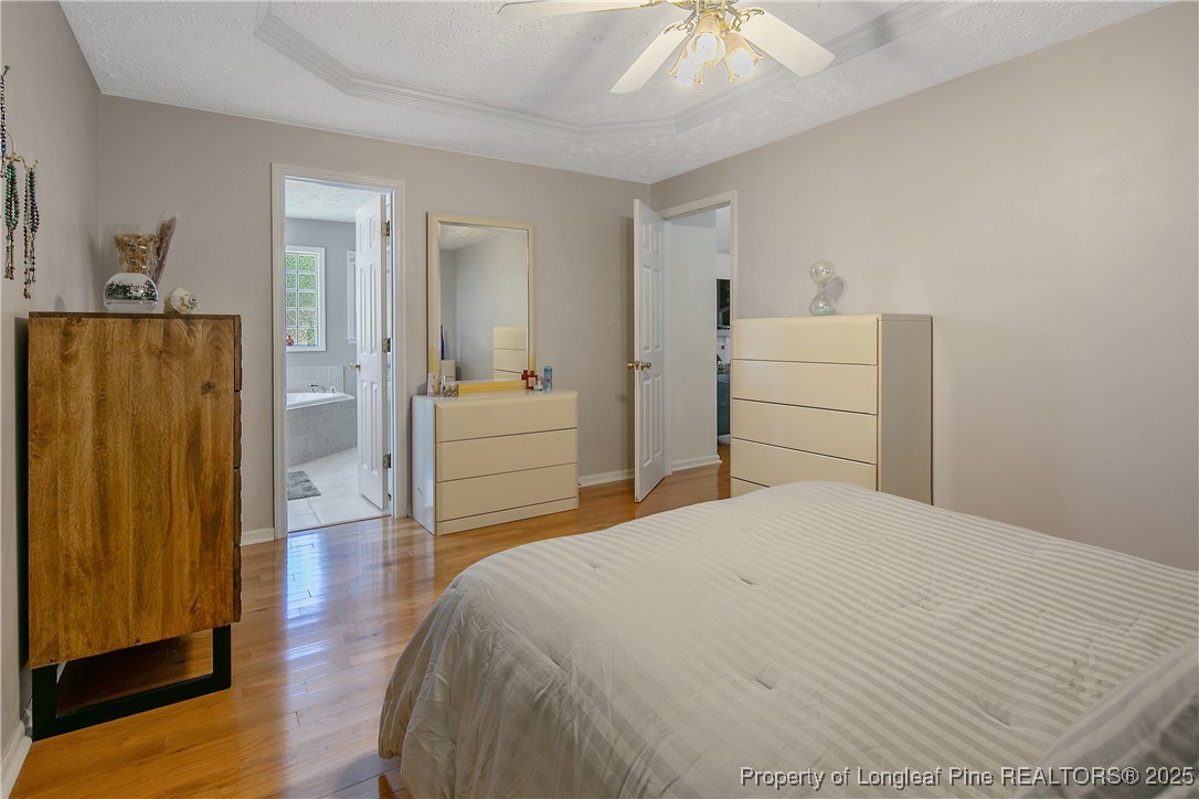 6528 Foxberry Road Fayetteville, NC 28314 - Photo 26 of 50 a bedroom with a bed and wooden floor