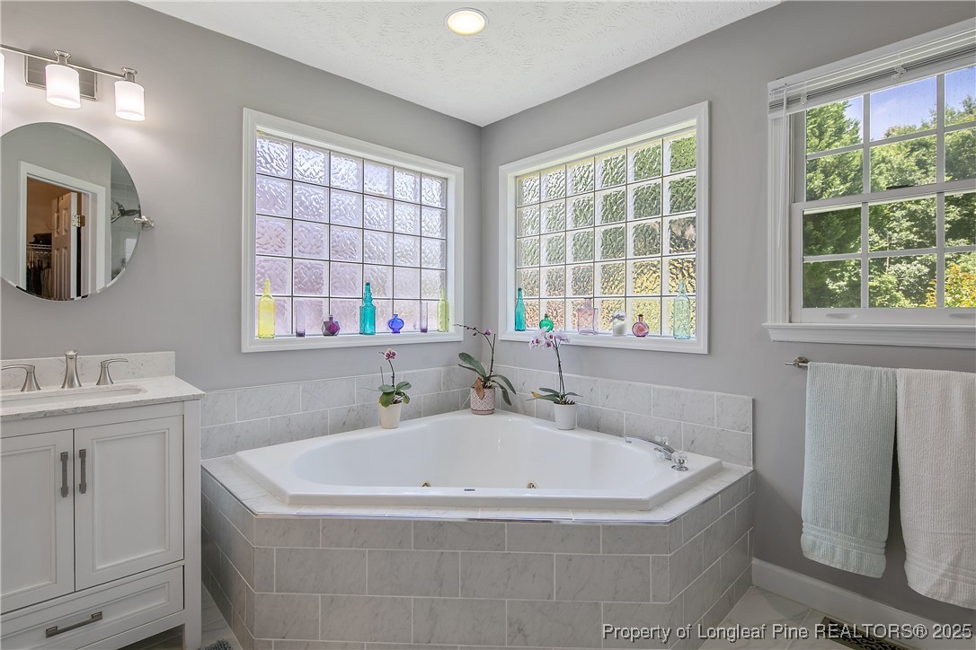 6528 Foxberry Road Fayetteville, NC 28314 - Photo 30 of 50 a white bath tub sitting in a bathroom next to a window
