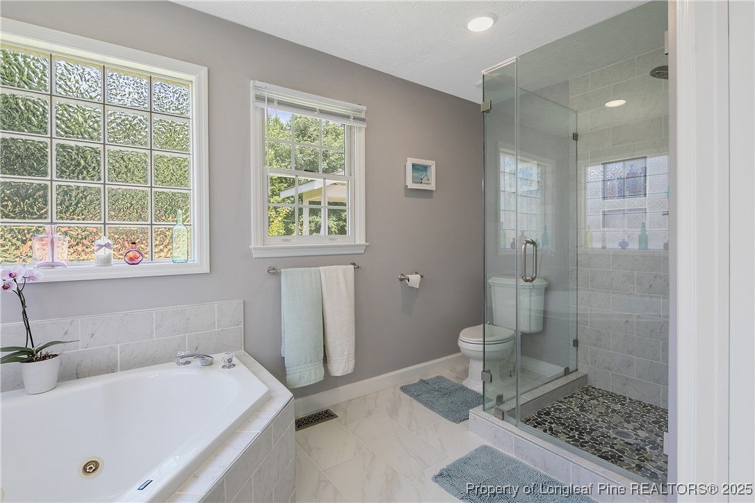 6528 Foxberry Road Fayetteville, NC 28314 - Photo 31 of 50 a bathroom with a tub a sink and a window