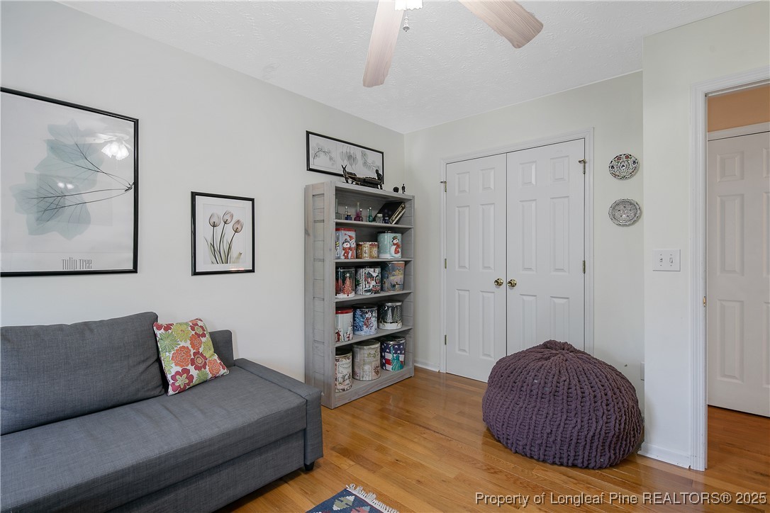 6528 Foxberry Road Fayetteville, NC 28314 - Photo 35 of 50 a living room with furniture and a book shelf