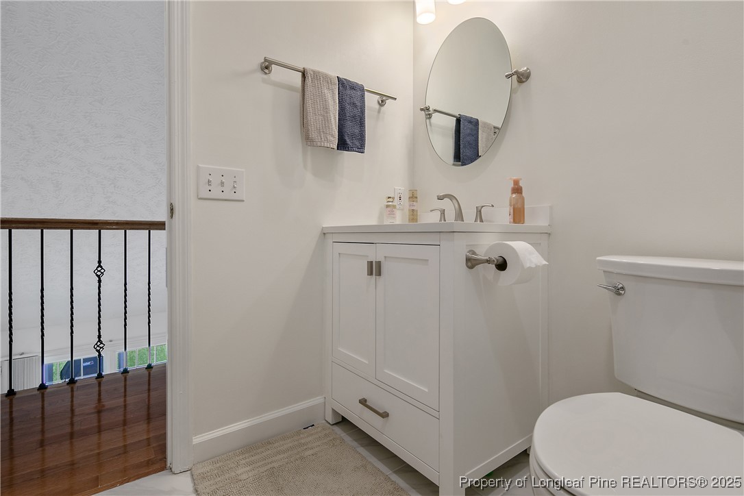 6528 Foxberry Road Fayetteville, NC 28314 - Photo 38 of 50 a bathroom with a sink a toilet a mirror and shower