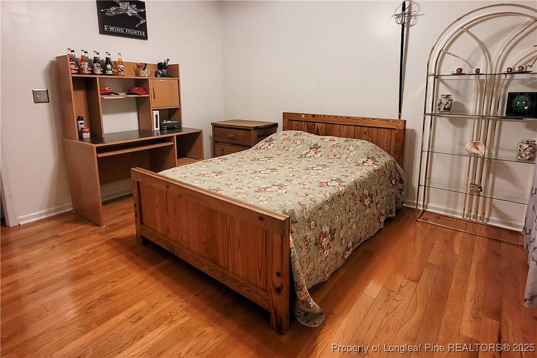 6528 Foxberry Road Fayetteville, NC 28314 - Photo 40 of 50 a bedroom with a bed and a flat tv screen on the dresser