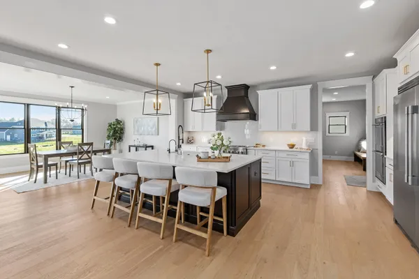 a view of a dining room with furniture wooden floor and chandelier