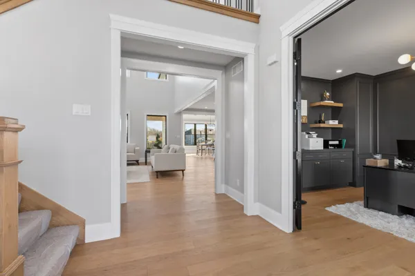 a kitchen with stainless steel appliances a dining table chairs sink and cabinets
