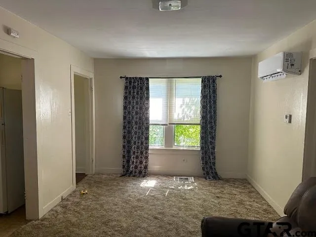 an empty room with windows and closet