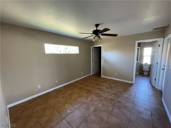 a view of a livingroom with a ceiling fan and window