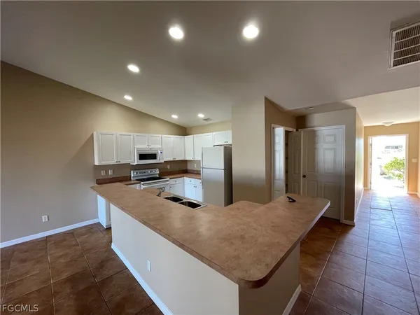 a view of an empty room with a fireplace and a window
