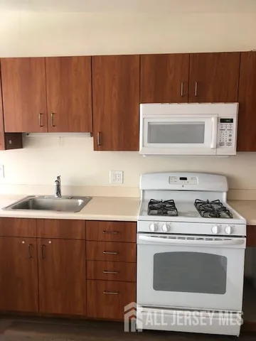 a kitchen with a cabinets and white stove