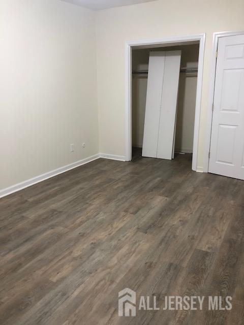 100 Albert Avenue Edison, NJ 08837 - Photo 5 of 14 an empty room with wooden floor