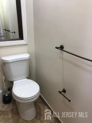 a white toilet sitting next to a bathroom sink