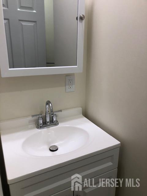 100 Albert Avenue Edison, NJ 08837 - Photo 8 of 14 a bathroom with a sink and cabinets