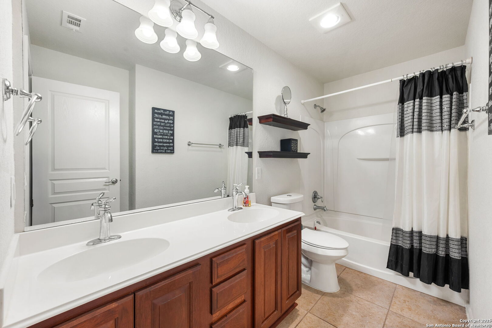 8206 Setting Moon San Antonio, TX 78255 - Photo 13 of 36 a bathroom with a double vanity sink toilet mirror and shower