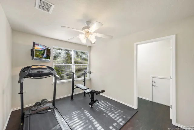 a view of a workspace with furniture and a window