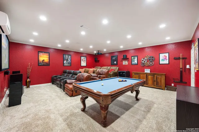 a room with wooden furniture and pool table