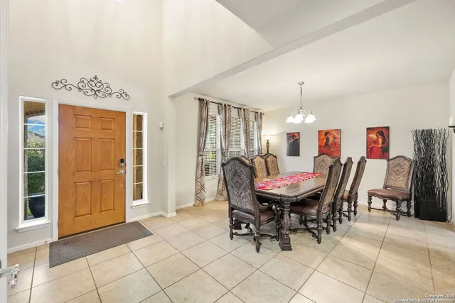 a living room with furniture a fireplace and a large window
