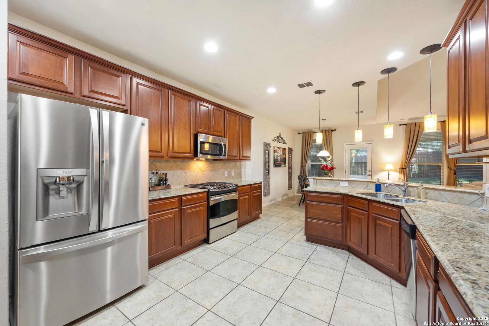 8206 Setting Moon San Antonio, TX 78255 - Photo 29 of 36 a large kitchen with stainless steel appliances granite countertop a stove top oven a refrigerator and a sink