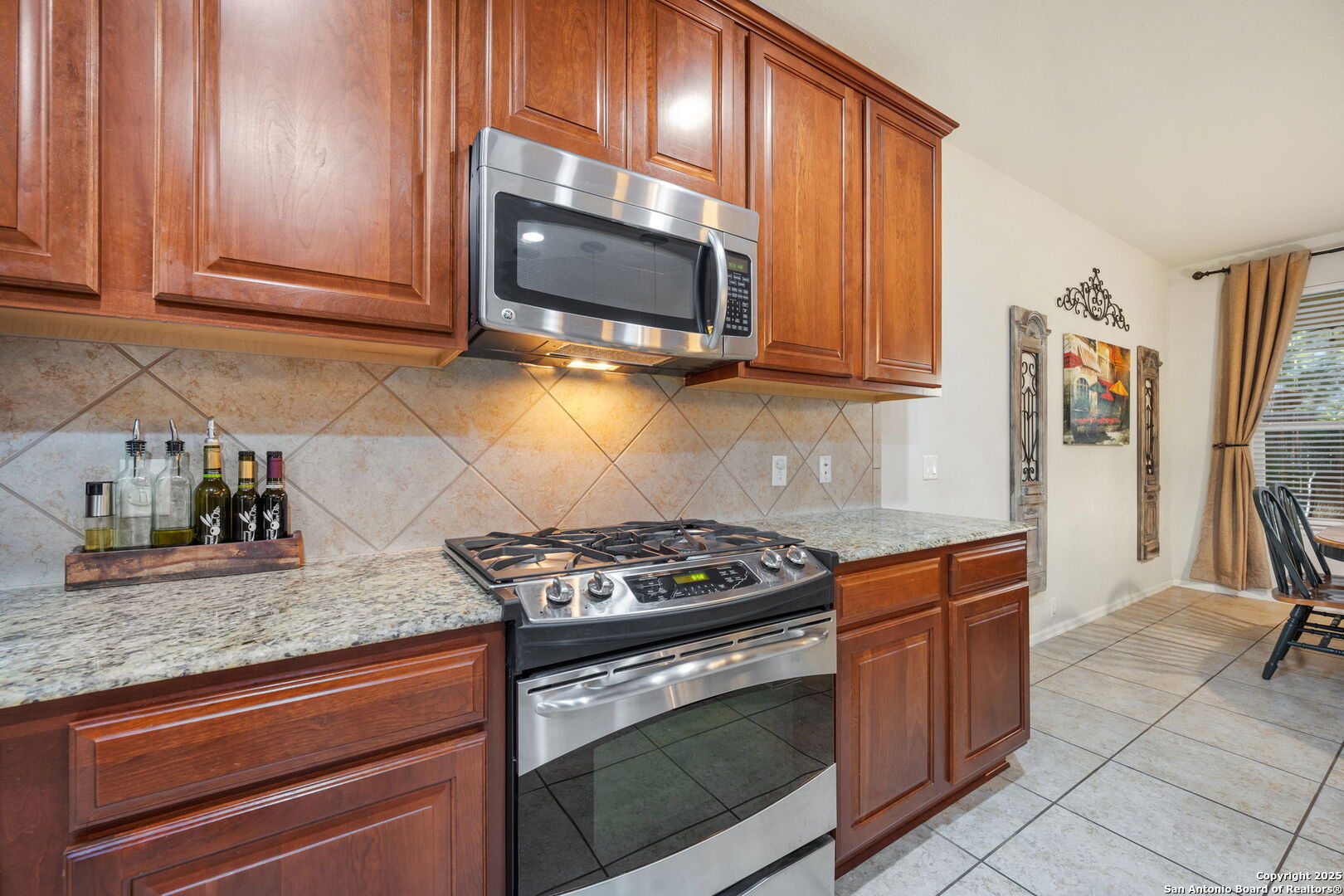8206 Setting Moon San Antonio, TX 78255 - Photo 30 of 36 a kitchen with stainless steel appliances granite countertop a stove microwave and cabinets
