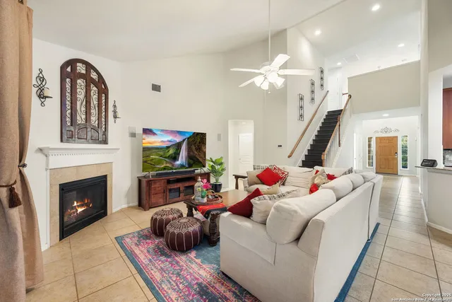 a living room with furniture fireplace and flat screen tv