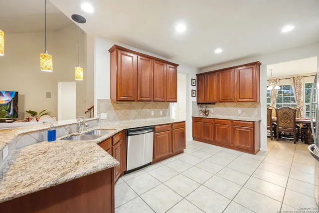 a kitchen with stainless steel appliances granite countertop a stove sink and cabinets